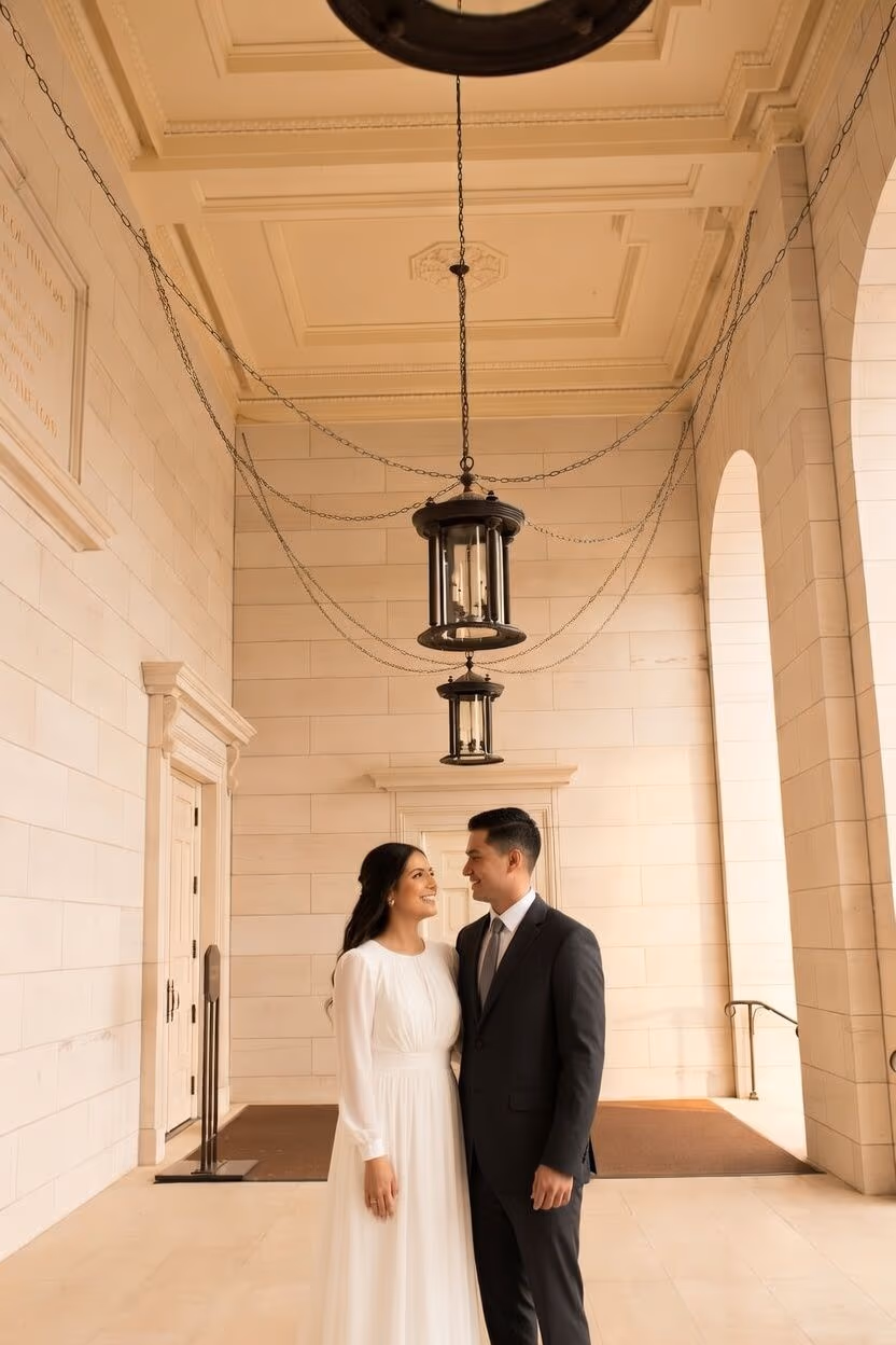 Bride and groom standing together beneath a temple archway